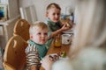 Family eating breakfast together in home kitchen. Healthy breakfast or snack before preschool, school and work. Royalty Free Stock Photo