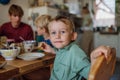 Family eating breakfast together in home kitchen. Healthy breakfast or snack before school and work. Royalty Free Stock Photo