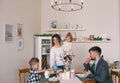 Family eating breakfast together in kitchen Royalty Free Stock Photo