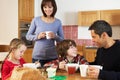 Family Eating Breakfast Together In Kitchen Royalty Free Stock Photo