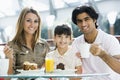Family eating cake in cafe Royalty Free Stock Photo