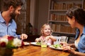 Family eating dinner at a dining table Royalty Free Stock Photo
