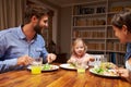 Family eating dinner at a dining table