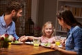 Family eating dinner at a dining table Royalty Free Stock Photo