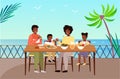 Family is eating fresh food. Afro american people are having dinner on the background of the beach