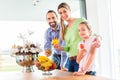 Family eating fresh fruits for healthy living in kitchen Royalty Free Stock Photo