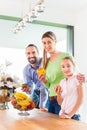 Family eating fresh fruits for healthy living in kitchen Royalty Free Stock Photo