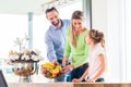 Family eating fresh fruits for healthy living in kitchen Royalty Free Stock Photo