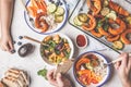 Family eating a healthy vegetarian food. Vegan lunch table top view, plant based diet. Baked vegetables, fresh salad, berries, Royalty Free Stock Photo