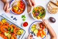 Family eating a healthy vegetarian food. Vegan lunch table top view, plant based diet. Baked vegetables, fresh salad, berries, Royalty Free Stock Photo