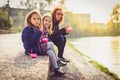 Family eating ice cream, sitting on banks of river Ljubljanica. Royalty Free Stock Photo