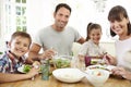 Family Eating Meal Around Kitchen Table Together