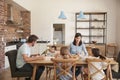 Family Eating Meal In Open Plan Kitchen Together Royalty Free Stock Photo