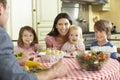 Family Eating Meal Together In Kitchen Royalty Free Stock Photo