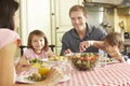 Family Eating Meal Together In Kitchen Royalty Free Stock Photo