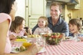 Family Eating Meal Together In Kitchen Royalty Free Stock Photo