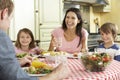 Family Eating Meal Together In Kitchen Royalty Free Stock Photo