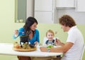 Family eating meat fondue Royalty Free Stock Photo