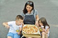 Family eating pizza outdoors. Street food concept. Royalty Free Stock Photo