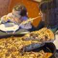 Family eating pizza in restaurant