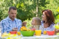 Family eating together outdoors at summer park Royalty Free Stock Photo