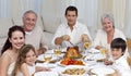 Family eating turkey in a celebration meal