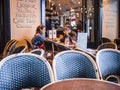 Family eats burgers at outside table at a cafe in Paris, France