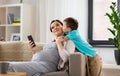 Son kissing happy pregnant mother at home Royalty Free Stock Photo