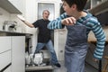 Family emptying the dishwasher Royalty Free Stock Photo