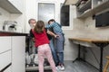 Family emptying the dishwasher Royalty Free Stock Photo