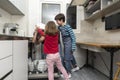 Family emptying the dishwasher Royalty Free Stock Photo