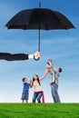 Family enjoy freedom at field under umbrella Royalty Free Stock Photo