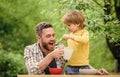 Family enjoy homemade meal. Food habits. Little boy with dad eating food nature background. Summer breakfast. Healthy Royalty Free Stock Photo