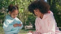 Family enjoy lunch picnic sitting park close up. African woman giving sandwich. Royalty Free Stock Photo