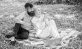 Family enjoy relax nature background. Couple bearded man and blonde woman relax nature while sit on green grass meadow Royalty Free Stock Photo