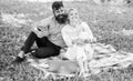 Family enjoy relax nature background. Couple bearded man and blonde woman relax nature while sit on green grass meadow Royalty Free Stock Photo