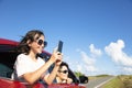 Family enjoy road trip taking picture by smart phone