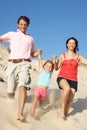 Family Enjoying Beach Holiday Running Down Dune Royalty Free Stock Photo