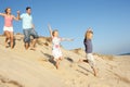 Family Enjoying Beach Holiday Running Down Dune Royalty Free Stock Photo