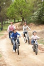 Family enjoying bike ride in park Royalty Free Stock Photo