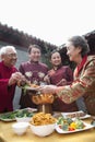 Family enjoying Chinese meal in traditional Chinese clothing Royalty Free Stock Photo