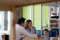 Potrait of asian family sitting inside enjoying the day at cafe in the morning