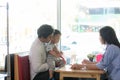 Potrait of asian family sitting inside enjoying the day at cafe in the morning
