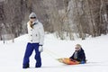 Family enjoying a day Snow sledding Royalty Free Stock Photo
