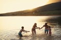 Family Enjoying Evening Swim In Countryside Lake Royalty Free Stock Photo