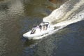 Family enjoying lunch over a boat in the midst of a river