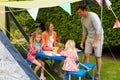 Family Enjoying Meal Outside Tent On Camping Holiday Royalty Free Stock Photo
