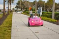 Family enjoying pink scoot coupe close to Piere 60 area in Gulf Coast Beaches 1 Royalty Free Stock Photo