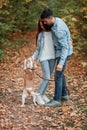 Family enjoying playing with pet outdoors Royalty Free Stock Photo