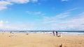 Family enjoying quality time in a sandy beach under a bright cheerful sky in Spain